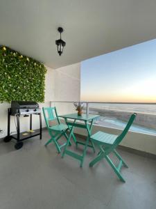a patio with two chairs and a table with a view at Laguna del mar La Serena in La Serena