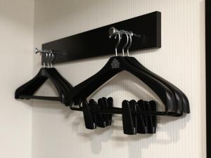 
a rack of ties hanging on a wall at APA Villa Hotel Nagoya Marunouchi Ekimae in Nagoya
