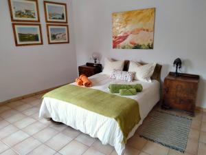 a bedroom with a bed with a stuffed animal on it at Casa Rural Altozano de Buendia in Buendía
