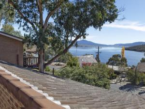 a stone wall with a view of a lake at Bundilla 4 Spacious Townhouse with Free Wifi in Jindabyne