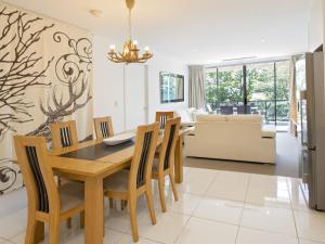 a dining room and living room with a table and chairs at The Edge Apartment 5 Jindabyne in Jindabyne