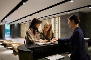 three women sitting at a table in a room at Oakwood Hotel Oike Kyoto in Kyoto