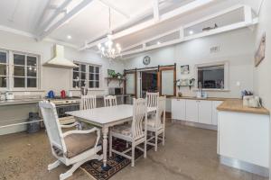 a kitchen and dining room with a table and chairs at A Whale's Tale Beach House in Amanzimtoti