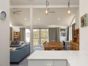 a living room with a couch and a table at Matilda Spacious centrally located with great lake views in Jindabyne