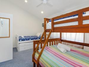 a bedroom with two bunk beds and a bed at Matilda Spacious centrally located with great lake views in Jindabyne