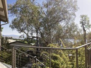 a staircase with a fence and trees in the background at Matilda Spacious centrally located with great lake views in Jindabyne
