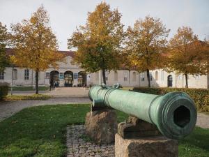 a large green cannon in front of a building at Nordsjællands Ferieboliger in Frederiksværk