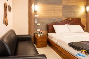 A bed or beds in a room at Naiyang Discovery Beach Resort SHA