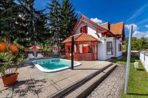 a house with a swimming pool in the yard at Holiday home Balatonbereny 18059 in Balatonberény