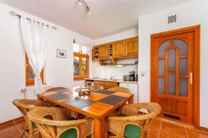 a kitchen with a wooden table and some chairs at Holiday home Balatonbereny 18059 in Balatonberény