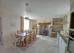 a kitchen and dining room with a table and chairs at Rowan House Holiday Home 