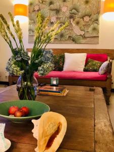 a living room with a couch and a table with a bowl of fruit at Villa Kunang in Seminyak