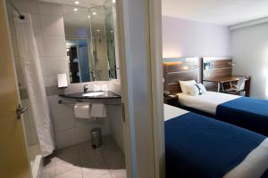 a hotel room with two beds and a sink at Holiday Inn Express Marseille Saint Charles, an IHG Hotel in Marseille