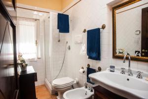 a bathroom with a sink and a toilet and a mirror at Villa Stella in Santa Margherita di Pula +30 photos