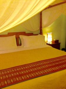 Tempat tidur dalam kamar di Villa Kunang