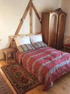 a bedroom with a large bed with a wooden headboard at Paulus Gästehaus Top3 in Salzburg