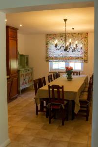 a dining room with a table and chairs at Biały Domek in Purda