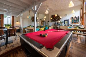 a ping pong table in a room with a pool table at Stayokay Hostel Haarlem in Haarlem