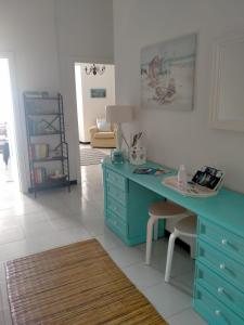 a room with a blue desk and a chair at Oltre Mare in Sori