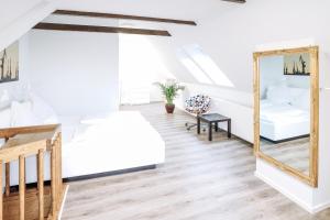 a bedroom with two beds and a mirror at Boardinghouse Rosenstraße in Hamburg