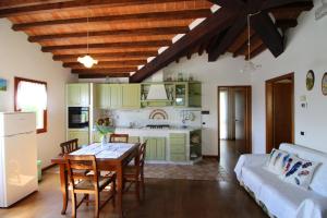 a kitchen and living room with a table and a couch at Villino Alba in Pieve a Maiano