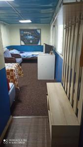 a room with two beds and a table in it at Бюджетне житло in Kunovka
