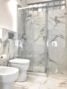 a bathroom with a shower and a toilet and a sink at Marco Polo Apartment in Milan