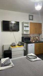 a room with a kitchen with a table and a bed at bvapartments-Blackhouse in Huddersfield