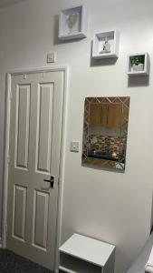 a room with a door and a mirror on a wall at bvapartments-Blackhouse in Huddersfield