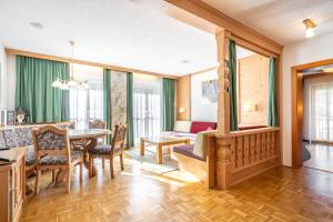 a living room with a table and a dining room at Dietrich Comfort Appartements in Telfs