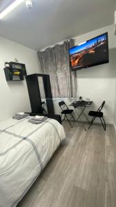 a bedroom with a bed and a flat screen tv at bvapartments-Queensgate 2 in Huddersfield