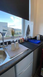 a kitchen counter with a sink and a window at bvapartments-Queensgate 2 in Huddersfield