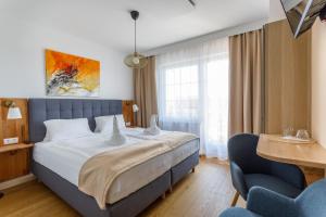 Posteľ alebo postele v izbe v ubytovaní Pension Laubenhof