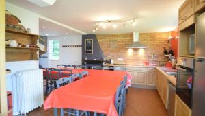 a large kitchen with an orange table and chairs at Rêve d'Etretat in Bordeaux-Saint-Clair
