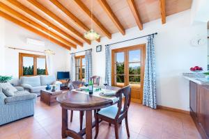 a kitchen and living room with a table and chairs at Villa Son Allarga in Costitx