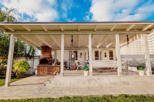 a wooden pergola on a deck with a fireplace at Lamera Residence Mamaia Apartments in Mamaia