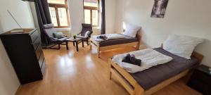 a room with a bed and a couch and chairs at Cozy 2 room flat with WLAN in Magdeburg