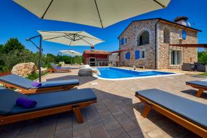 a villa with a swimming pool and a building at Relax house surrounded by olives and vineyard in Stifanići