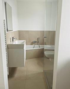 a bathroom with a sink and a toilet at Ammersee Haus in Haus,wunderschöne Designerferienwohung mit Garten in Dießen am Ammersee