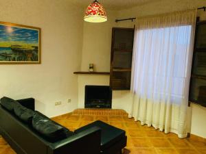 a living room with a couch and a fireplace at Apartamento Los Laureles in Laroles