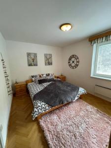 a bedroom with two beds and a rug at APARTMA ODKLOP Rogla in Lukanja