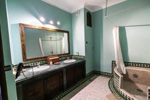 a bathroom with two sinks and a tub and a mirror at Riad Dar Chrifa - Luxury Escape in Fez +71 photos