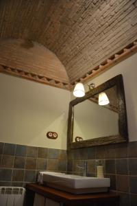 a bathroom with a mirror and a sink at Leyendas de Monfragüe in Torrejón el Rubio