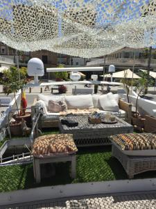 a rooftop patio with couches and tables on a building at The boathouse in Málaga