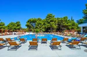 a large pool with chairs and people in it at Croatia Camp Mobile Homes Vodice in Vodice