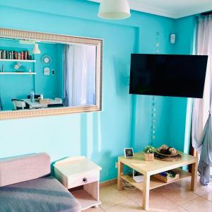 ein Wohnzimmer mit einer blauen Wand und einem großen Spiegel in der Unterkunft Shanti, La Casa Azul in Palm-mar