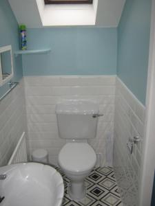 a bathroom with a white toilet and a sink at Slieve Elva B&B in Lisdoonvarna +26 photos