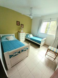 a bedroom with two beds and a window at La Alquimia Casas de Campo in La Granja