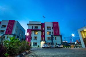 a building with cars parked in front of it at Professionals Friendly with Work Station PS5 & near Beaches in Lekki