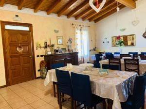 a dining room with tables and blue chairs at Bed & Breakfast Bellavista in Castiglione delle Stiviere